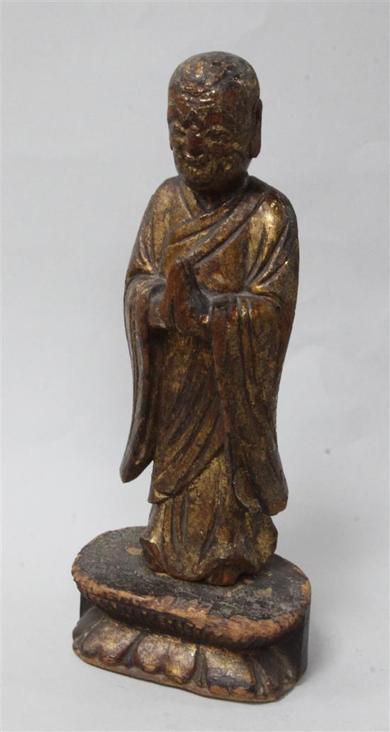 A Chinese giltwood figure of a Luohan, Ming dynasty or earlier, height 21.5cm